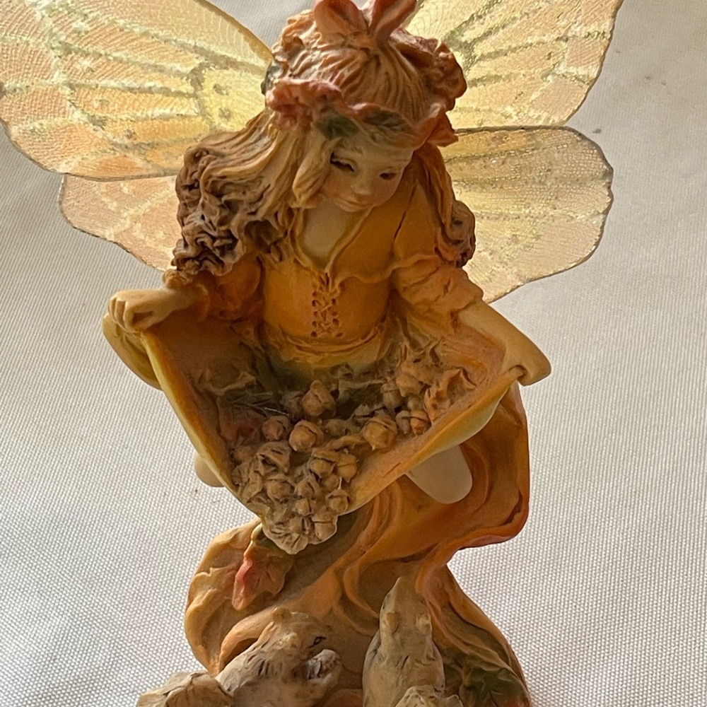 Beautiful fall fairy gathering acorns for her squirrel friends. By Jessica